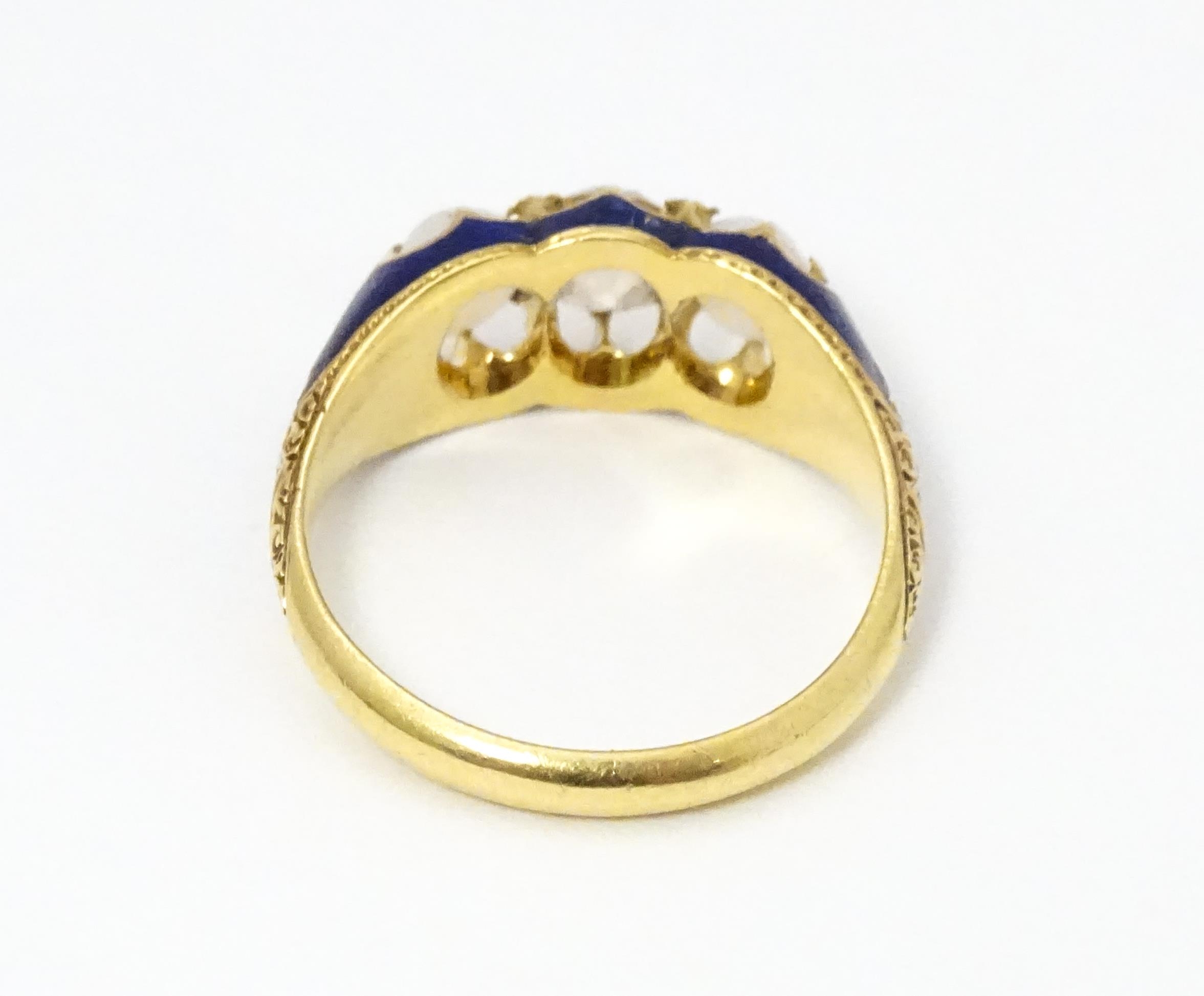 A 19thC yellow gold ring set with central diamond flanked by opals in a blue enamel setting. Ring - Image 4 of 4