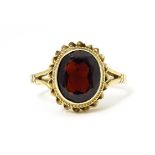 A 9ct gold ring set with central garnet. Ring size approx M Please Note - we do not make reference