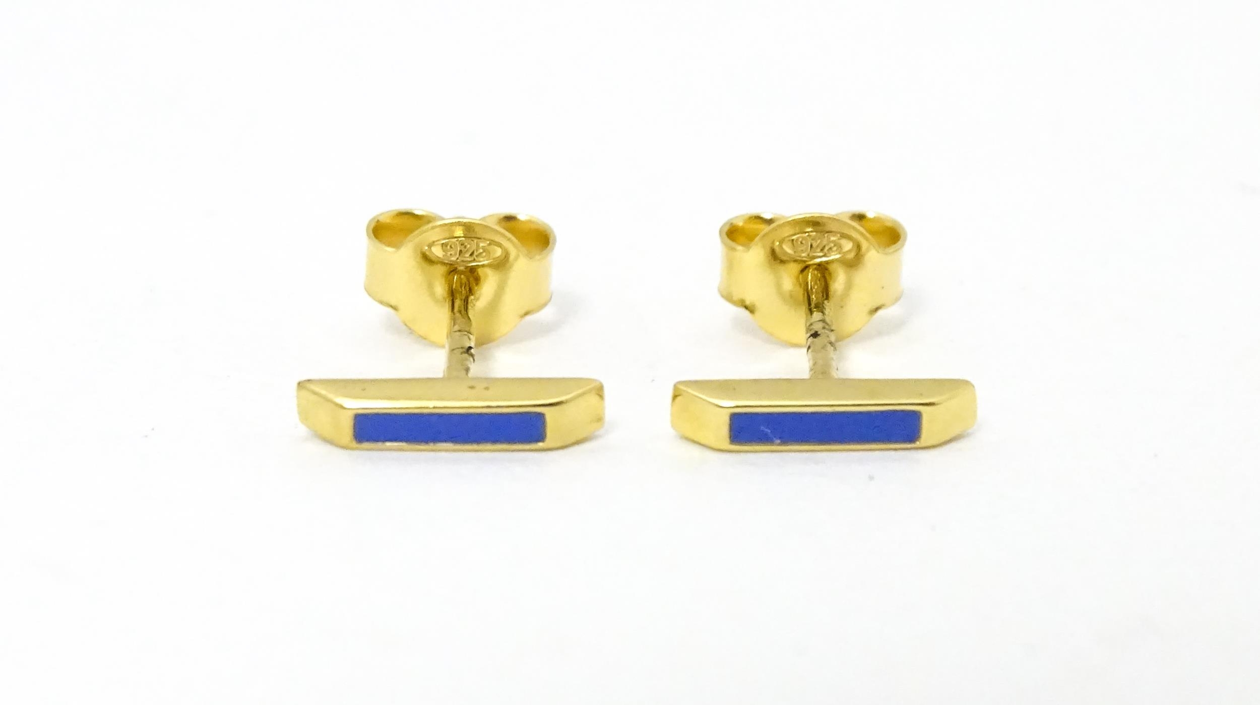 A pair of Astley Clarke 925 silver gilt stud earrings with blue enamel detail. Approx. 1/4" wide
