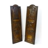 A pair of 19thC carved oak cupboards with rounded tops, panelled doors, fluted pilasters and