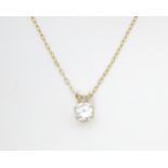 A pendant set with white stone solitaire on a 9ct gold chain. 16" long Please Note - we do not