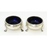 A pair of Geo III silver salts with blue glass liners. London 1764 maker David Mowden 2 1/2" wide (