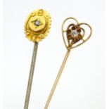 Two gold and gilt metal stick pins set with diamonds, including a 15ct gold example. Approx 2 1/4"