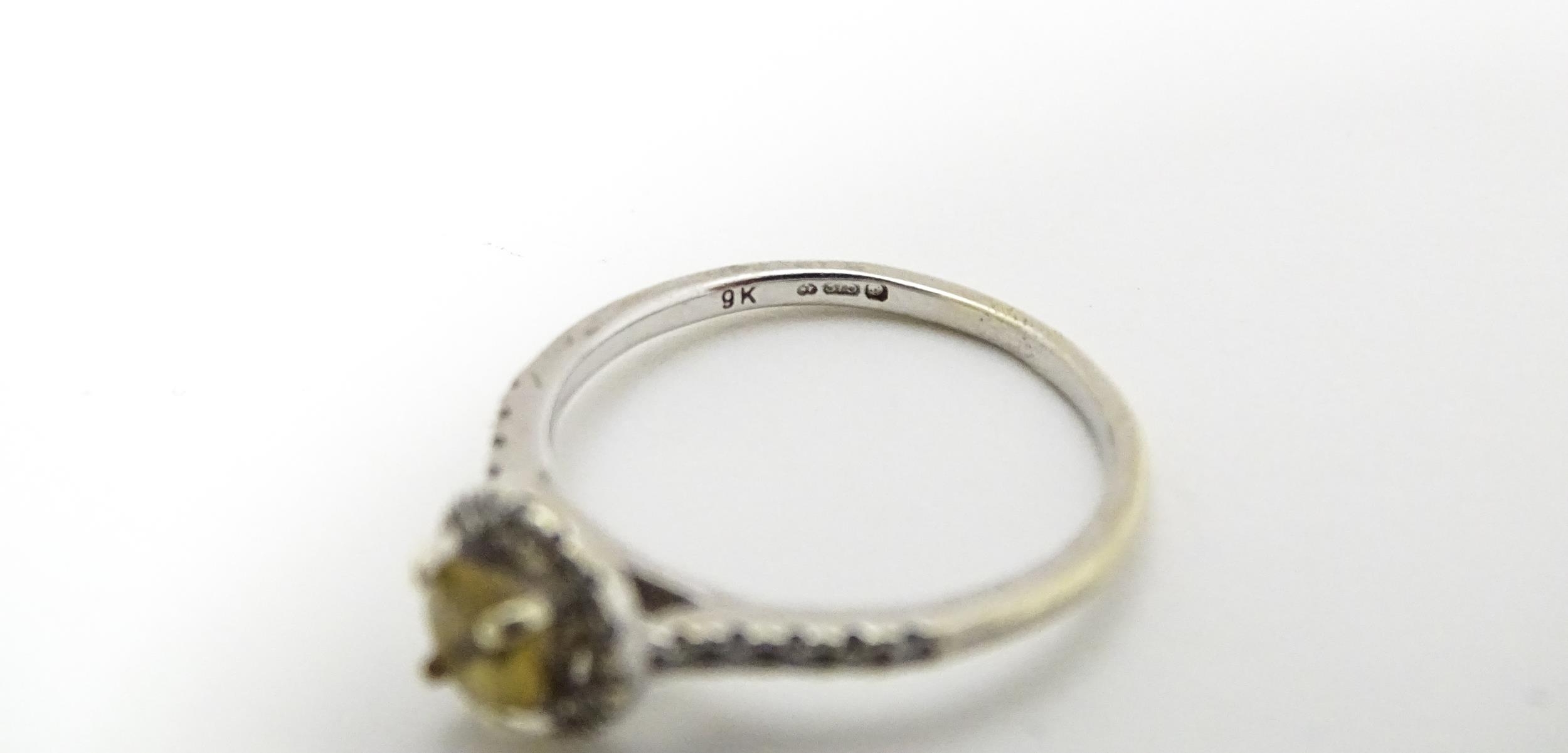 A 9ct white gold ring set with central citrine coloured stone bordered by diamonds and with - Image 3 of 5