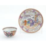 A Miles Mason style tea bowl and saucer in the pattern Boy At Door, depicting Oriental figures in