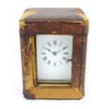 A brass carriage clock with French movement by Duverdry & Bloquel, the white enamel dial with