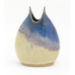 A Greek studio pottery vase by Kamini with asymmetric drip glaze. Impressed marks lower. Approx. 8