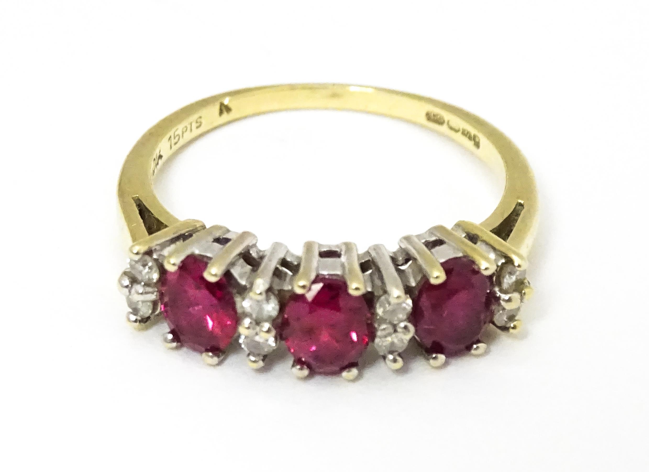 A 9ct gold ring set with rubies and diamonds. Ring size approx K 1/2 Please Note - we do not make