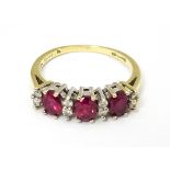 A 9ct gold ring set with rubies and diamonds. Ring size approx K 1/2 Please Note - we do not make