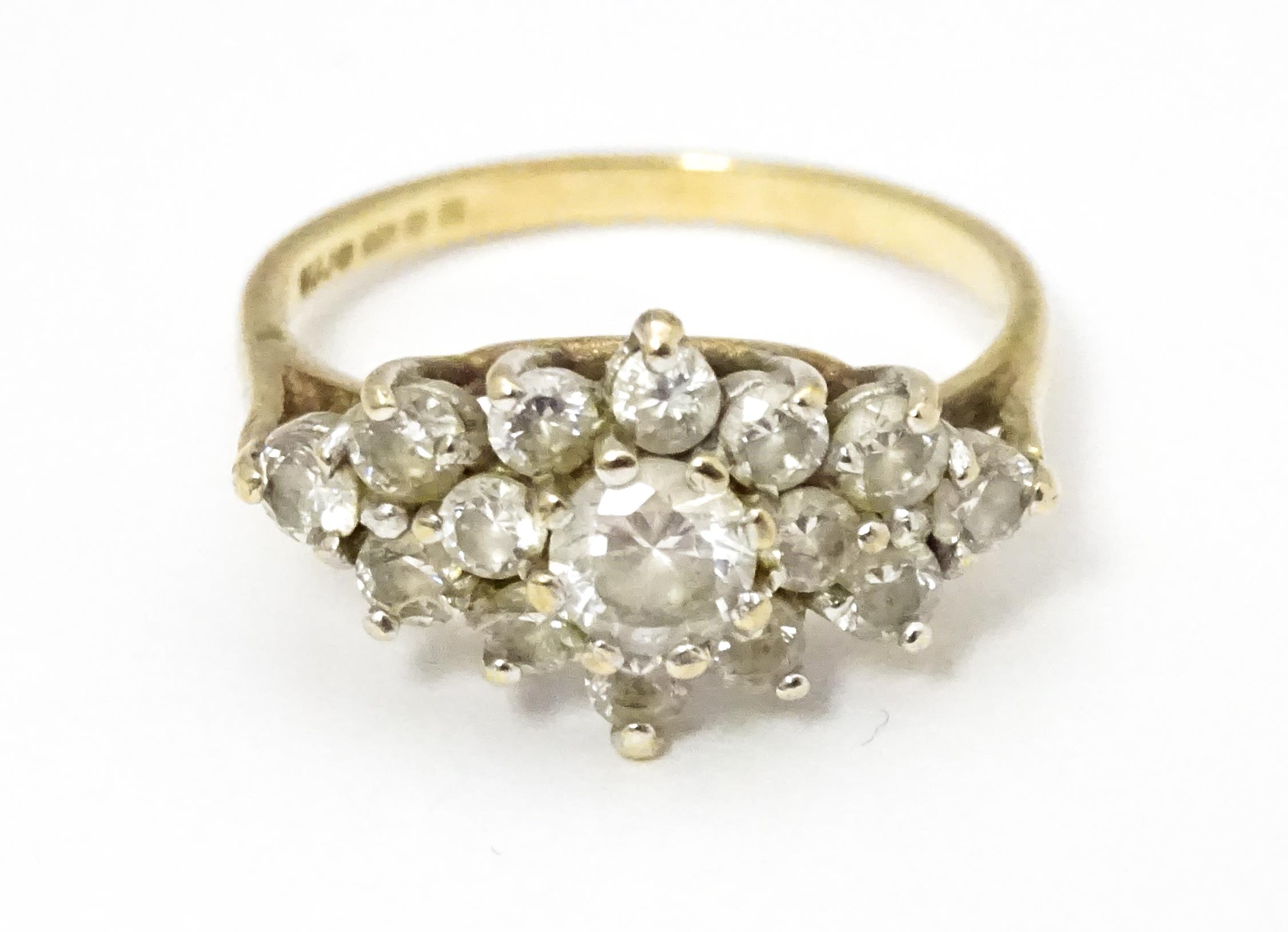 A 9ct gold ring set with cluster of white stones. Ring size approx. J 1/2 Please Note - we do not