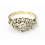 A 9ct gold ring set with cluster of white stones. Ring size approx. J 1/2 Please Note - we do not