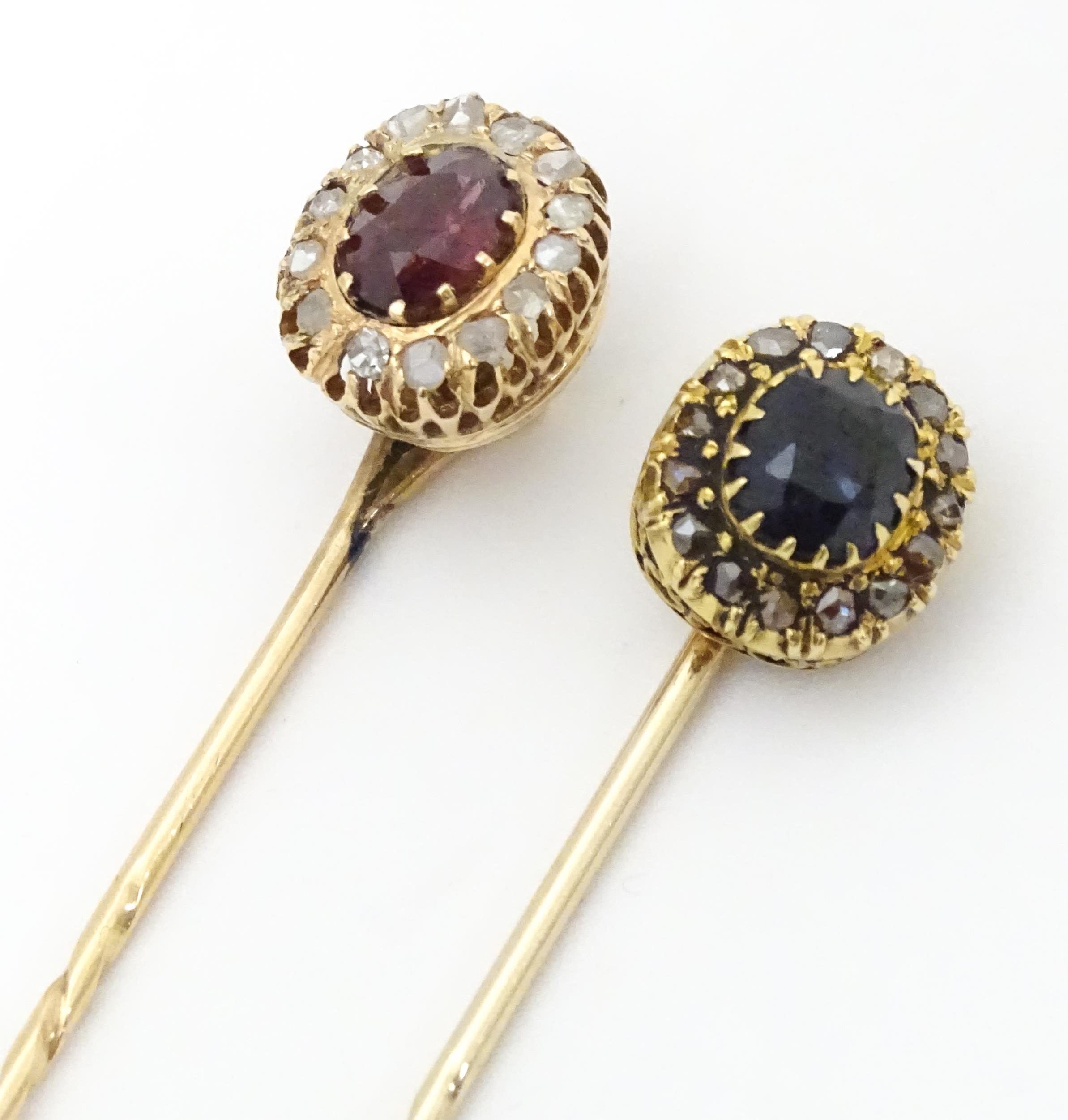 Two yellow metal stick pins, one surmounted by a central sapphire bordered by diamonds, the other - Image 4 of 6