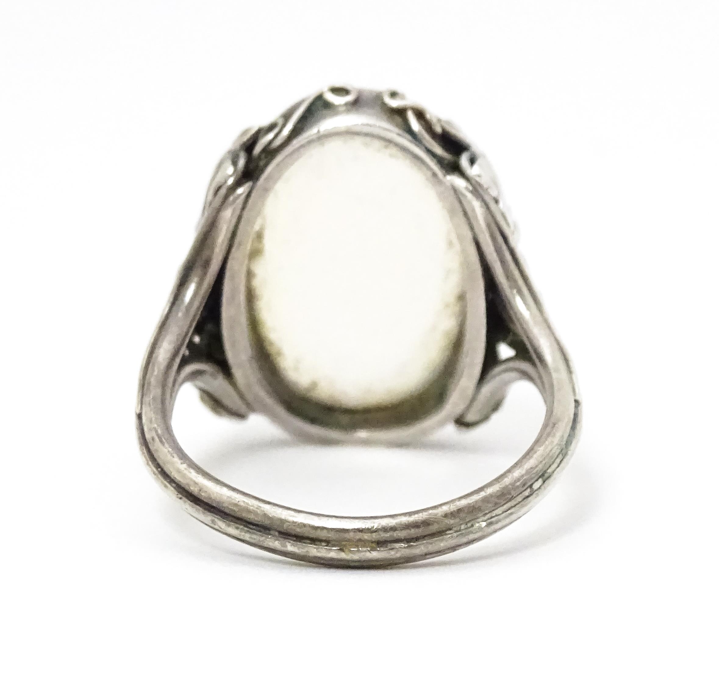 A white metal ring set with central oval moonstone cabochon and with fruiting vine detail to - Image 3 of 6