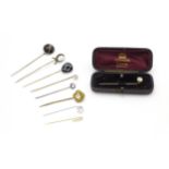 Nine assorted gilt and yellow metal stick pins set with various white stones, hardstone, agate