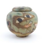 A studio pottery Smiler Jar / lidded moon jar by Chris Bramble with incised face detail. Marked