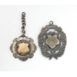 Two silver fob medallions, one hallmarked Chester 1915 and another stamped Dance & Duerden Morley