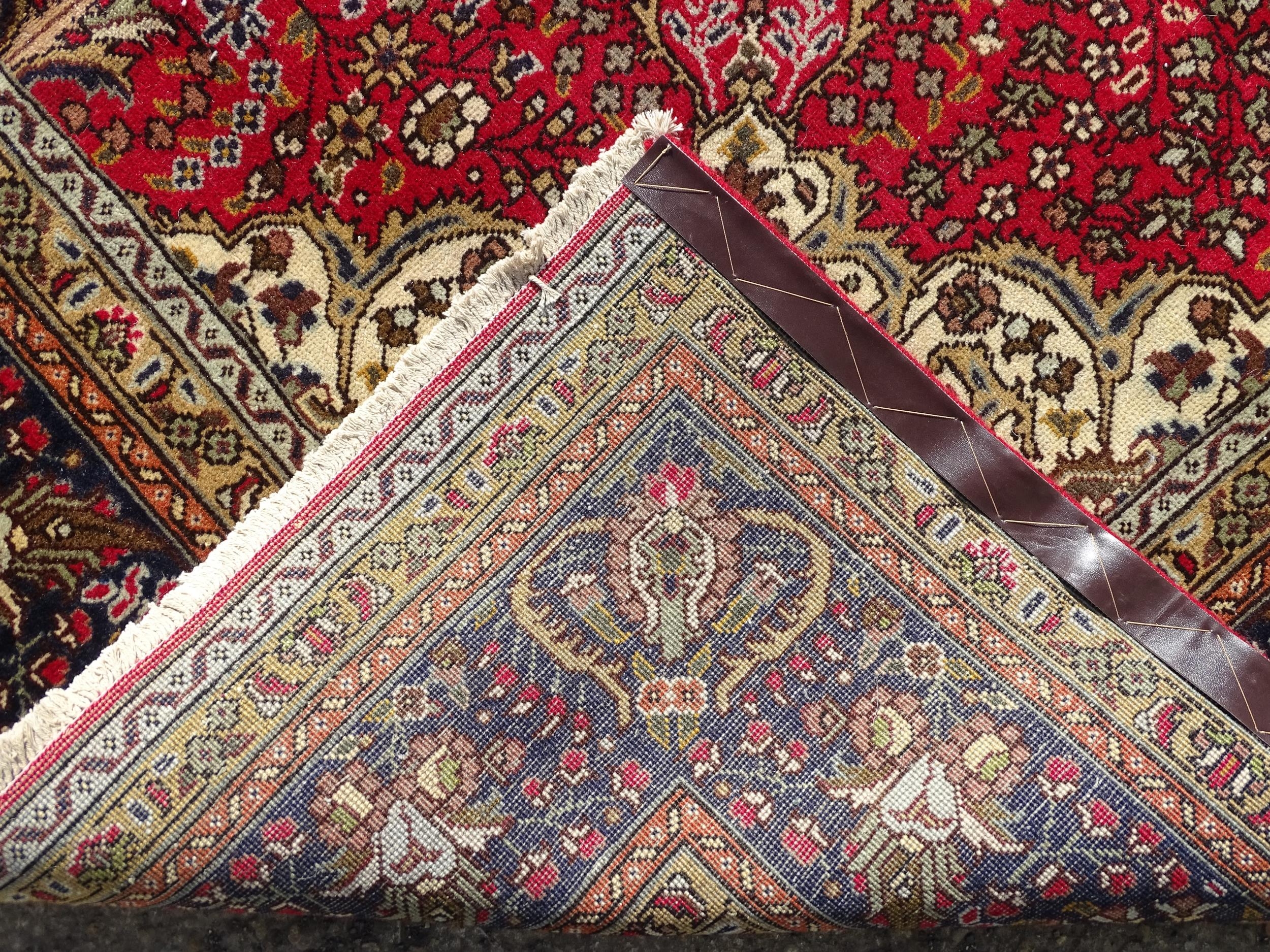 Carpet / Rug : A North West Persian Tabriz carpet, the red ground with central medallion of floral - Image 2 of 6