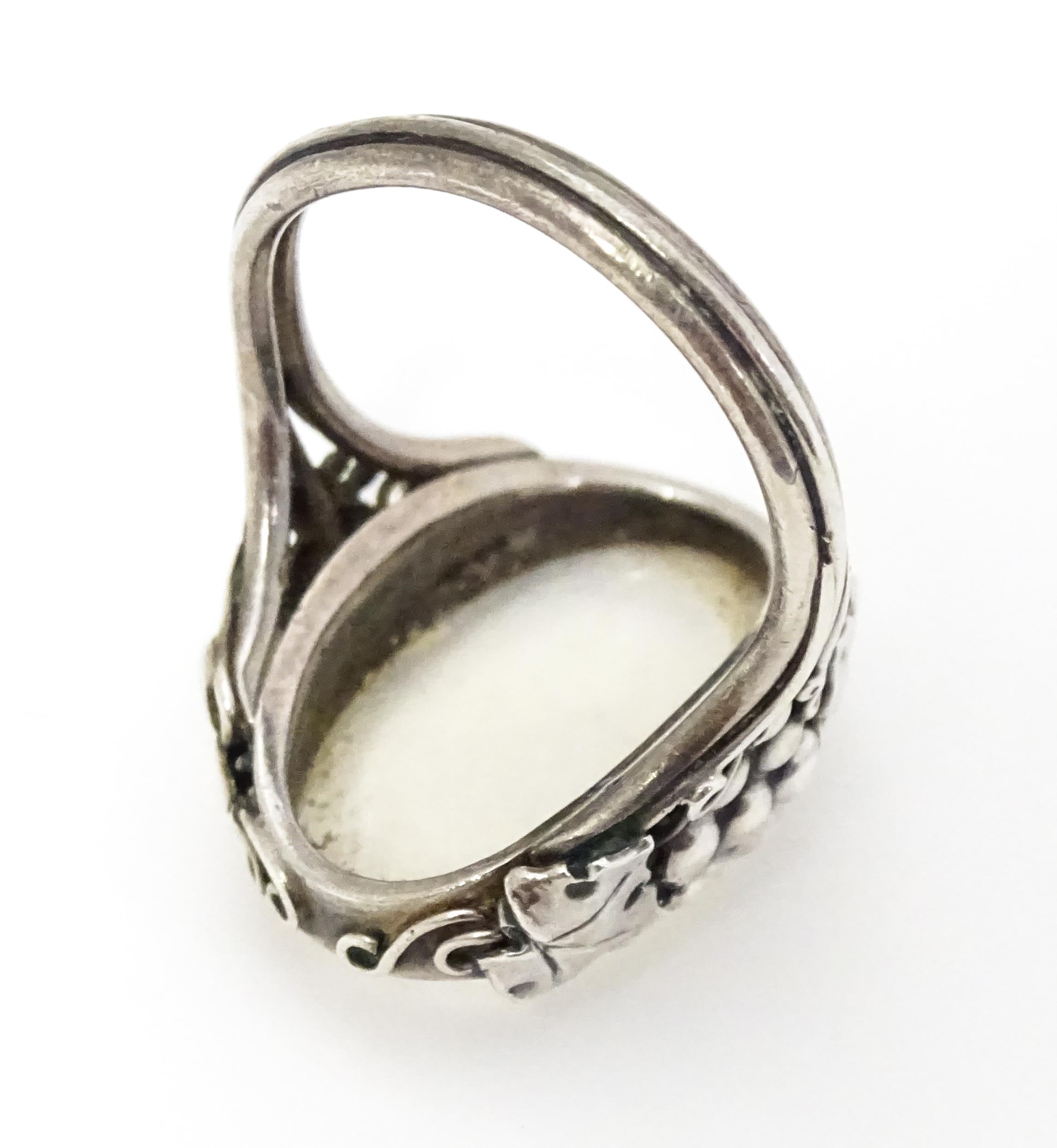 A white metal ring set with central oval moonstone cabochon and with fruiting vine detail to - Image 4 of 6