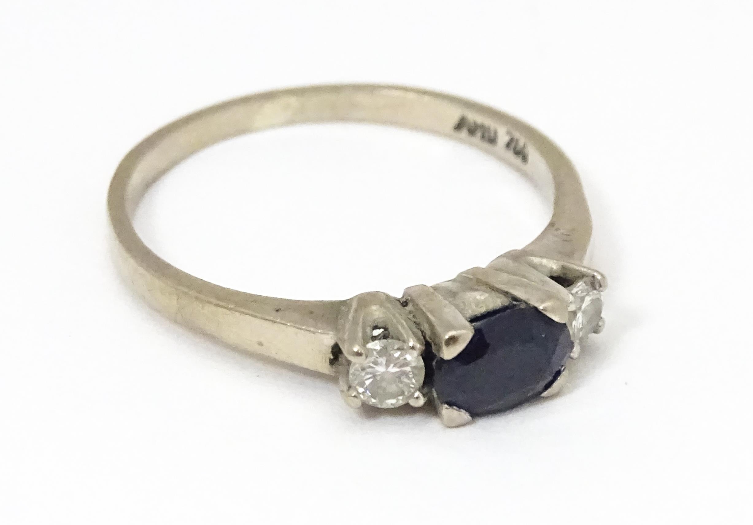 An 18ct white gold ring set with central sapphire flanked by diamonds. Ring size approx. M 1/2 - Image 5 of 6