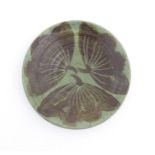 A studio pottery dish by Sybil Finnemore for Yellowsands Pottery with leaf / petal decoration. Bears