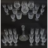 A large quantity of cut glass / crystal glassware to include champagne flutes, assorted drinking