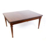 A late 20thC mahogany dining table with two additional leaves. The moulded table top raised on