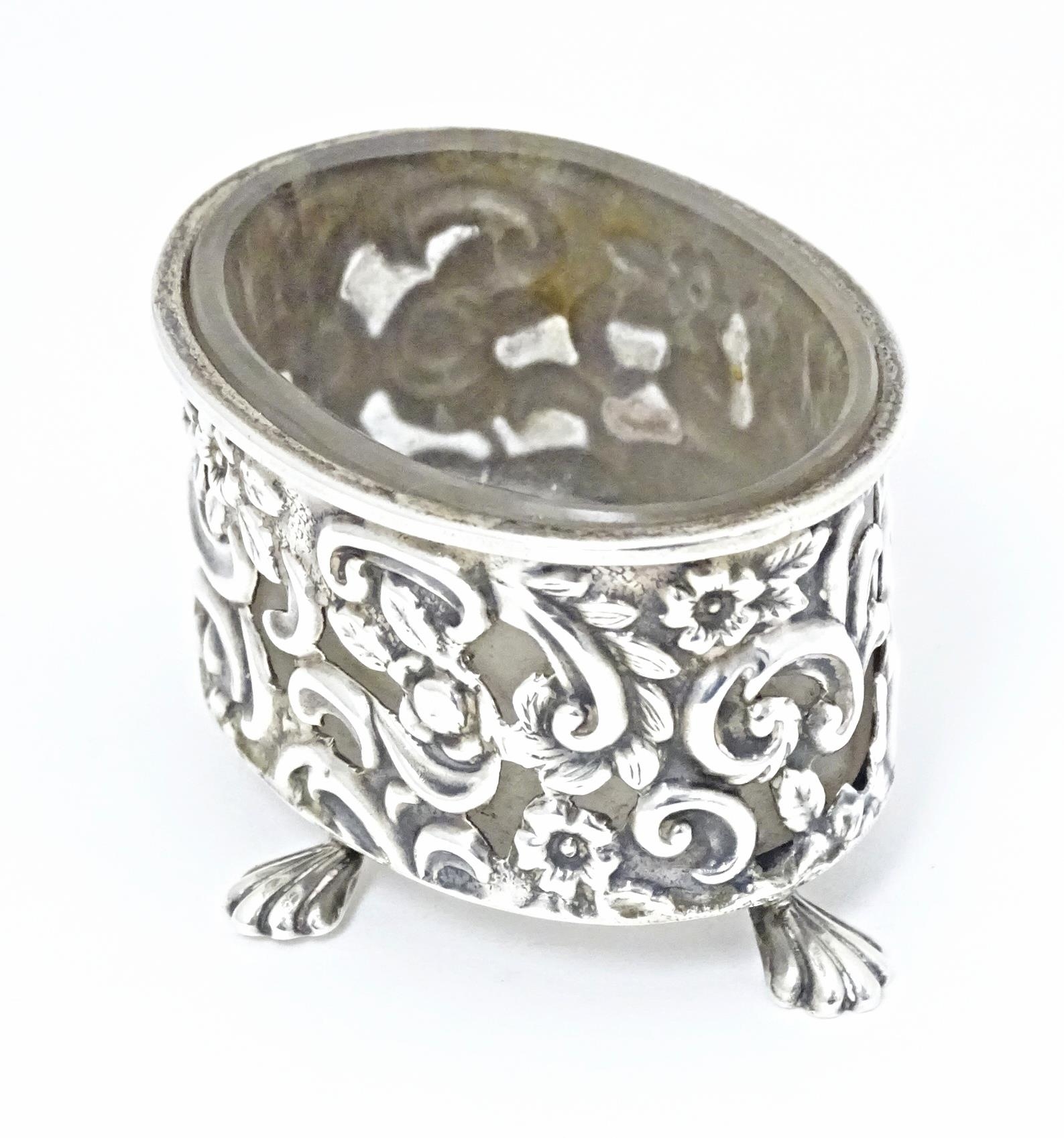 A Victorian silver salt of oval form with embossed decoration and four stylised paw feet, and - Image 4 of 7