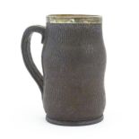 A Victorian Doulton Lambeth stoneware leather jack jug with a silver rim hallmarked London 1894,