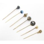 Seven assorted gilt metal stick pins set with various turquoise, enamel decoration, etc. Largest