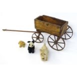 Toys: A late 19th / early 20thC small wooden pull along cart with drawbar and four wheels.