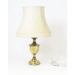 A brass table lamp of urn form, standing approx 22 1/2" high (inc. shade) Please Note - we do not