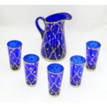 A blue glass lemonade / water set comprising jug and five beakers. Please Note - we do not make