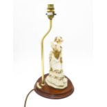 A Leonardo figural table lamp, the mahogany oval stand with brass upstand and lady in Edwardian