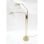 A brass standard lamp with twin adjustable lights, approx 70 1/2" high. Please Note - we do not make