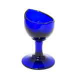 A blue glass eye bath. Approx. 2 3/4" high Please Note - we do not make reference to the condition