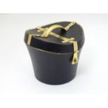 A 21stC novelty brass caddy / container formed as a saddle shaped hat box with black leather