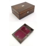 A Victorian rosewood writing box with inlaid mother of pearl to top, opening to reveal a fitted