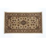 A beige ground rug. Approx. 24" x 43 1/2" Please Note - we do not make reference to the condition of