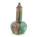 A majolica bottle vase and cover with relief decoration depicting the snuff taker. Approx. 10"