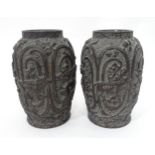 A pair of plaster cast vases with bird and ox detail in relief. Approx. 10 1/4" high (2) Please Note