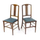 A pair of Edwardian mahogany side chairs with satinwood inlaid stringing, the chairs raised on