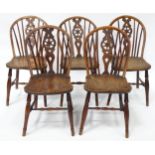 A set of five late 19thC / early 20thC wheelbase dining chairs with shaped elm seats and raised on