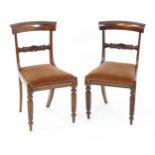 A pair of 19hC mahogany side chairs, with bowed top rails, carved mid rails, drop in seats and