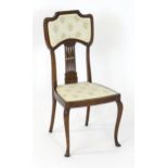 An Edwardian mahogany Nouveau style side chair, having an upholstered backrest and seat with a