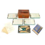 Toys: A 20thC Chinese bone and bamboo Mahjong set within a leather case with five lift out trays.