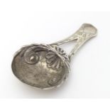 A Geo III silver caddy spoon with engraved decoration and bifurcated handle . Hallmarked