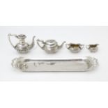 A silver 5 piece miniature / dolls house tea set comprising tea pot, coffee pot, sugar bowl and