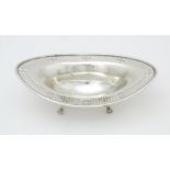 A Victorian Scottish silver bon bon dish of ovoid form with pierced detail and raised on four