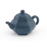 A Chinese Yixing teapot of hexagonal form with a blue ground. Character marks under and to underside