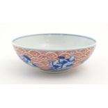 A Chinese blue, white and pink bowl the exterior decorated with the Eight Immortals upon their